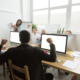 diverse colleagues congratulating black coworker with good result or win